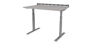 electric height adjustable Symbiote Symple table on glides with laminate surface, surface mounted plug strip